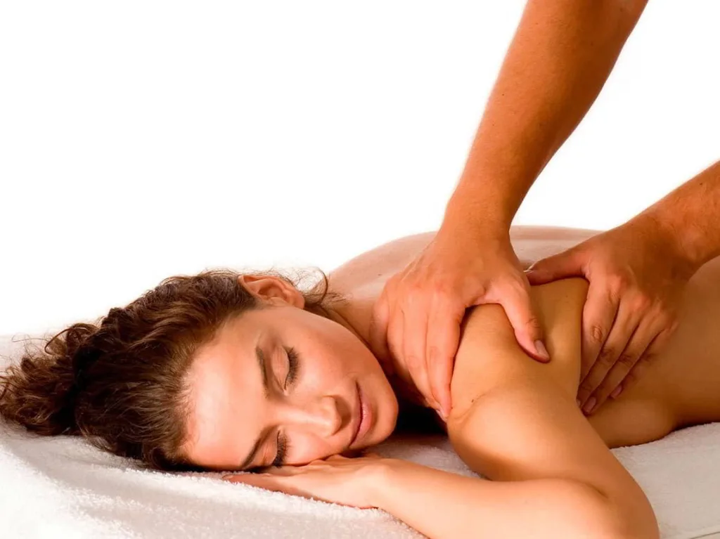 Mujer tumbada recibiendo un masaje de Fisioterapia